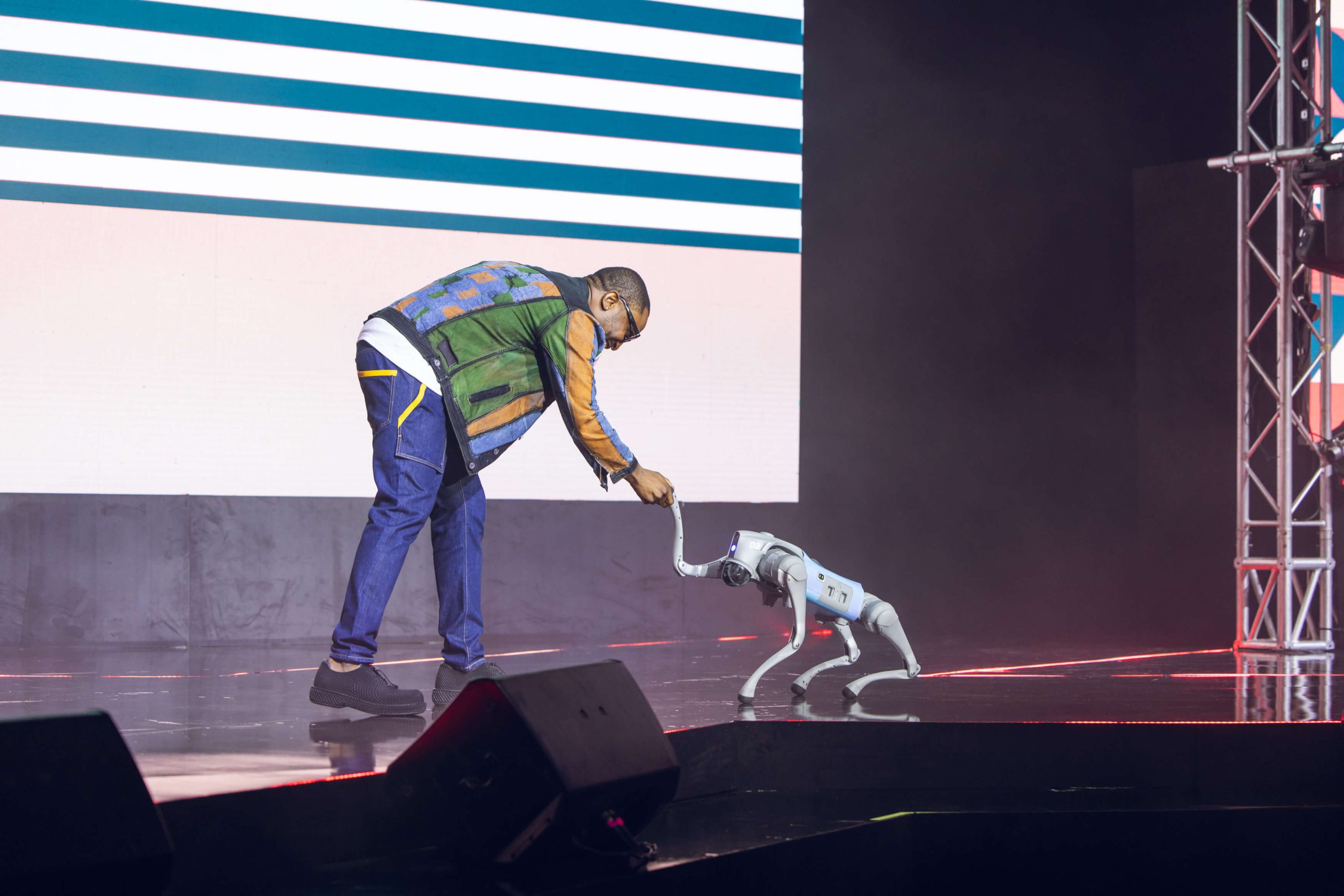 man shaking a robot dog