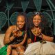 two ladies at a table smiling