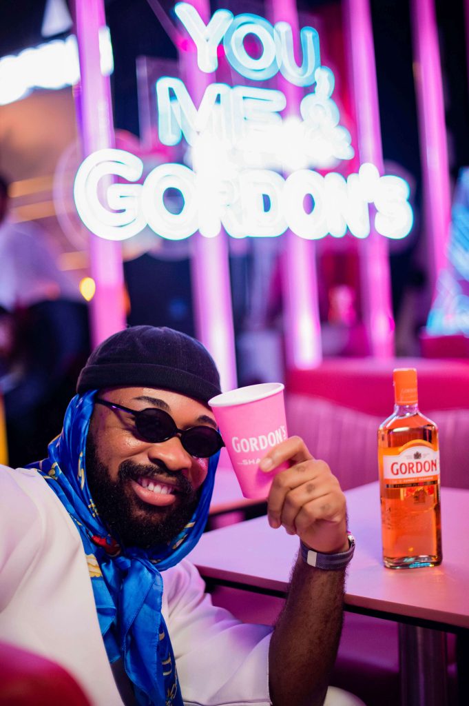 man posing with Gordon's cup